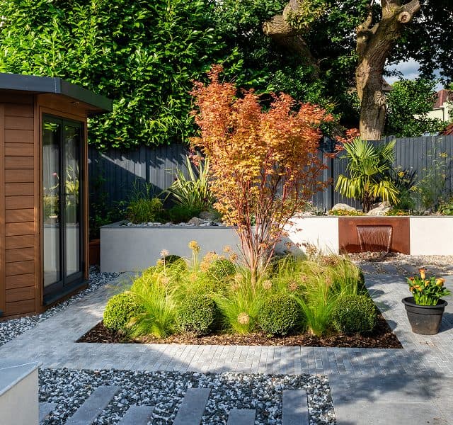 Architectural garden room beside landscaped planting