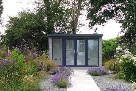 Insulated cedar garden room with full-height glazed doors